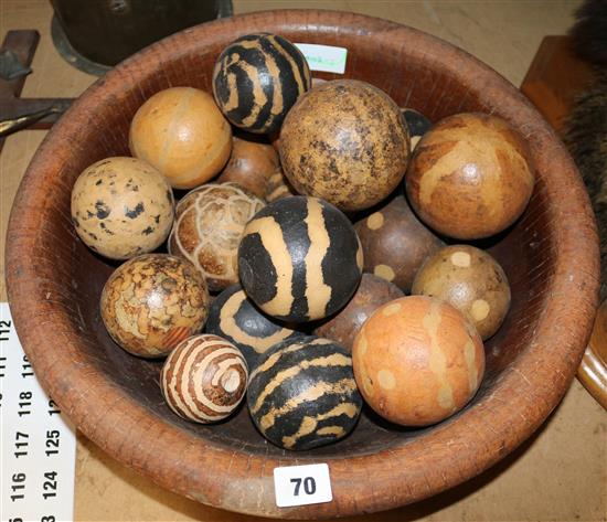 A collection of gourds in a papier-mache bowl